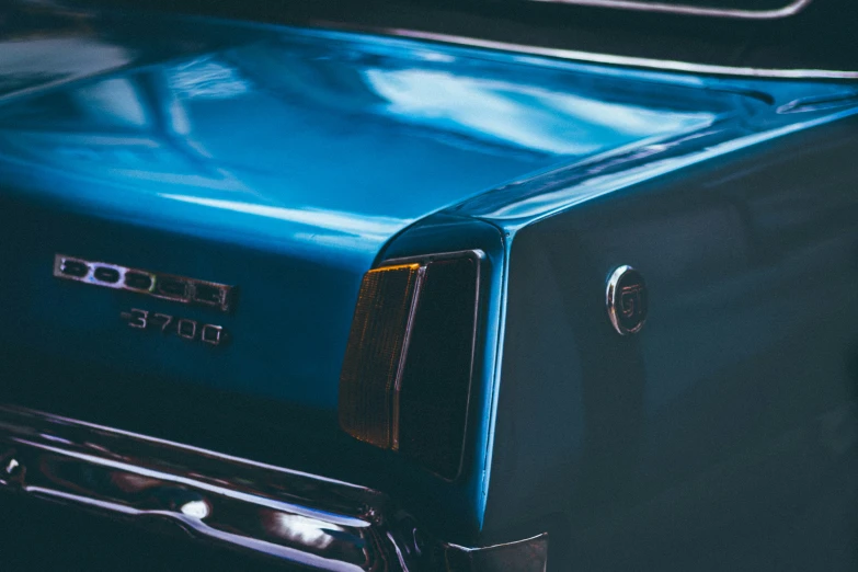 a closeup of an antique blue classic car with the hood up