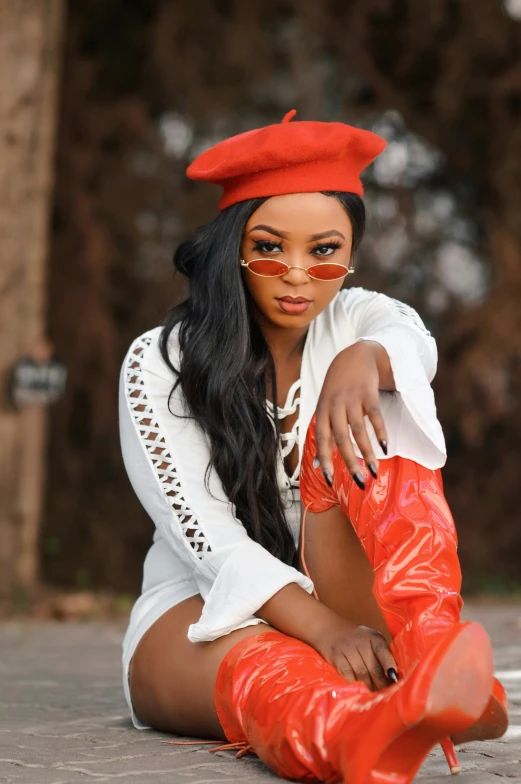 an attractive black woman with a red hat