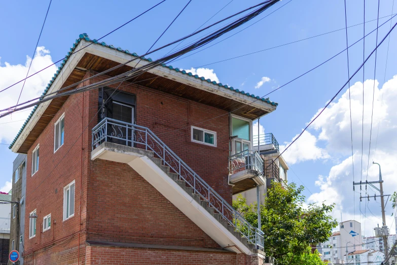 a red brick building with an open balcony