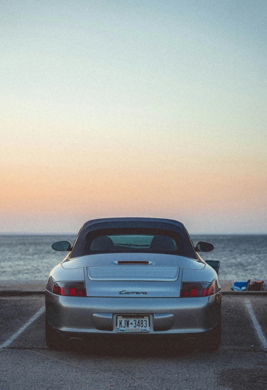 a silver bmw sports car parked on a parking lot