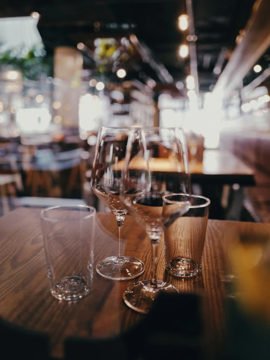 three glasses sitting on top of a wooden table