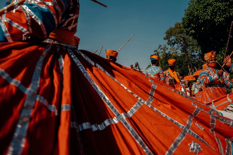 people are gathered around in long red dresses and headdress