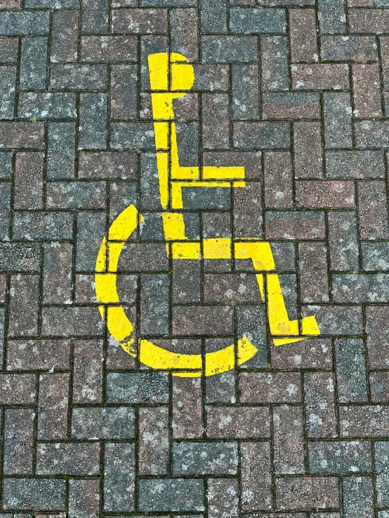 the handicapped symbol on a brick walkway