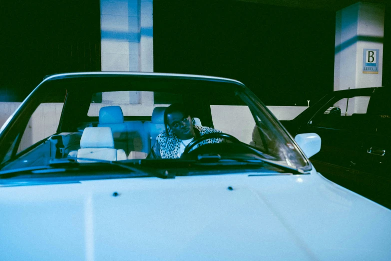 a blue car with its front seats covered by another car