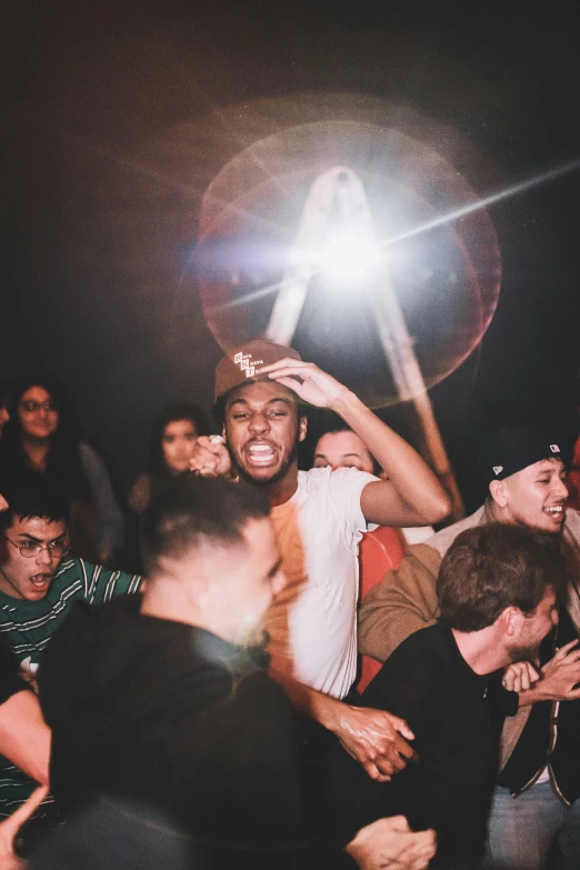 a group of men are holding up a frisbee