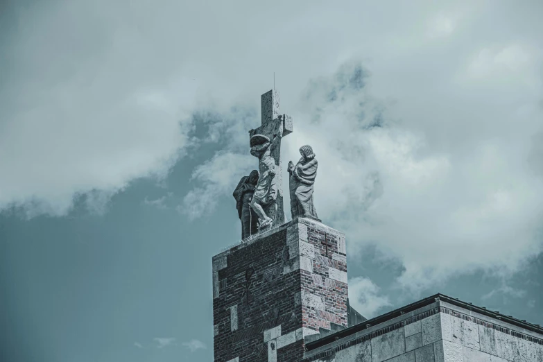 a large building with a very tall statue on the top of it