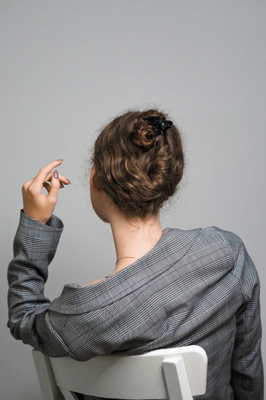 woman in striped shirt sitting in a chair and holding a cigarette