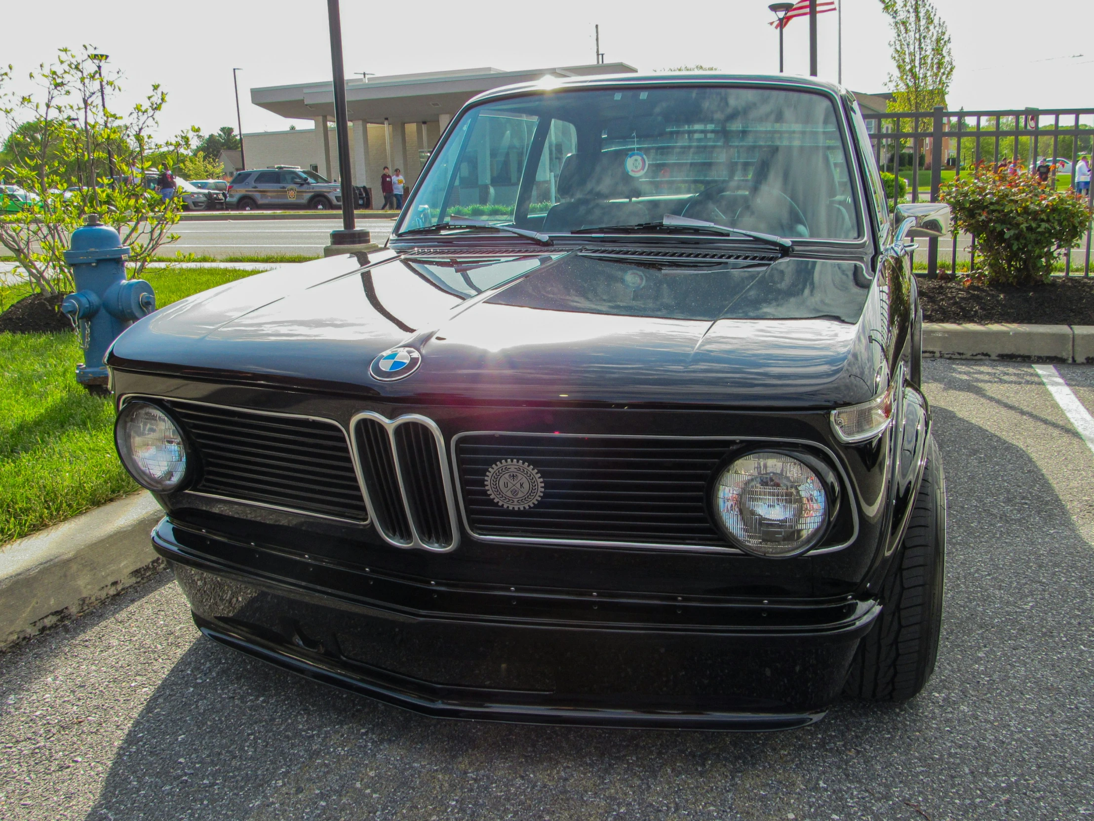 a black and chrome car parked on the side of the road