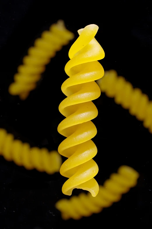 a spiraly yellow object is pographed against a black background