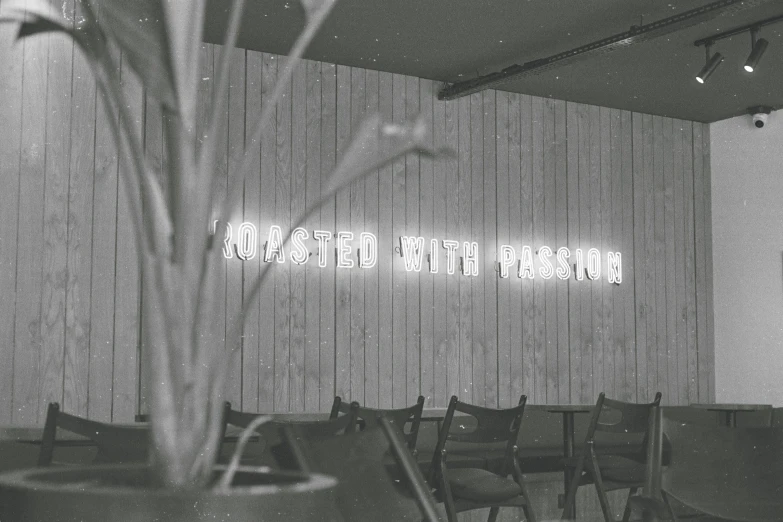 a sign is displayed on a wooden wall in a restaurant