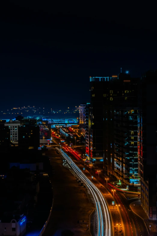 a city with tall buildings at night with light trails