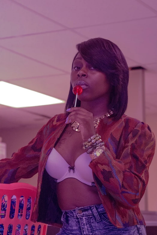 a woman holding a straw looking up while holding a candy cane