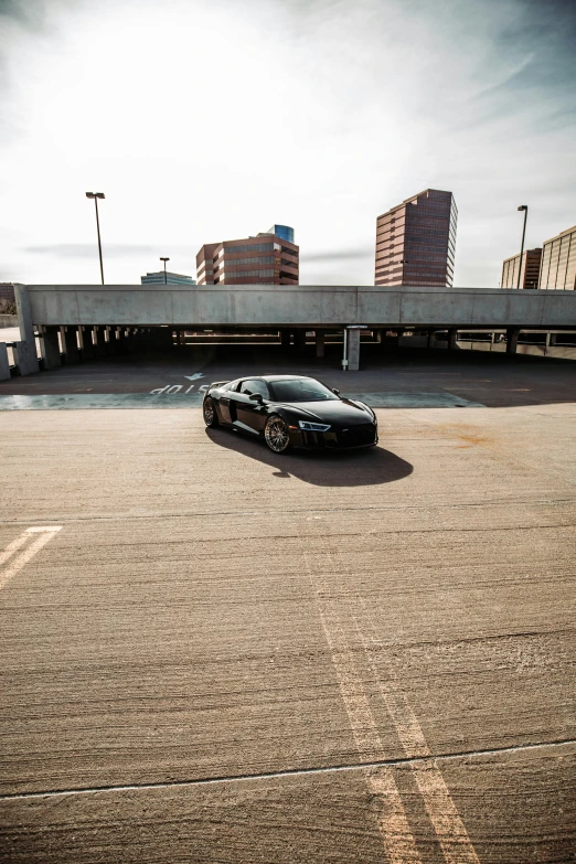 a sports car is parked in a empty parking lot