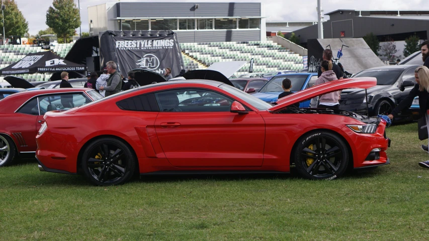 a red car on display in a field