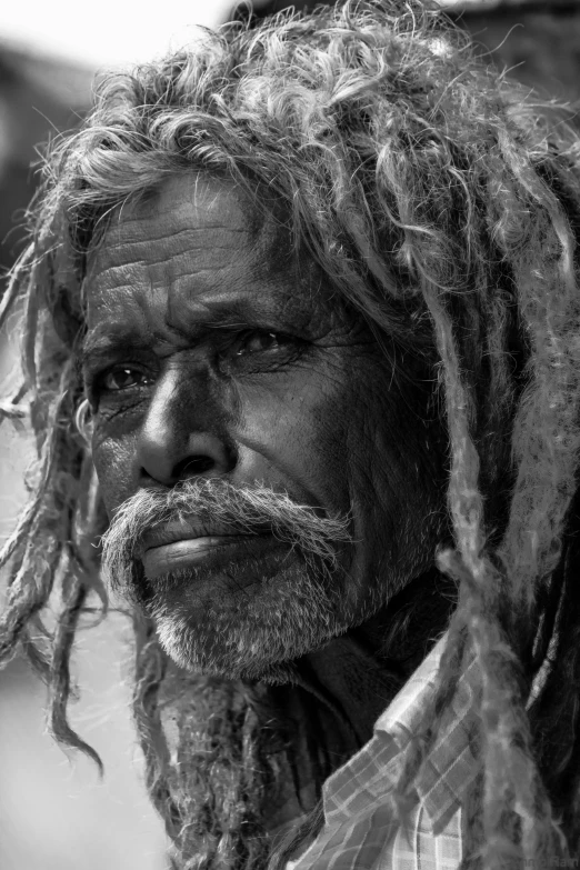 an elderly man with dreads and tattoos