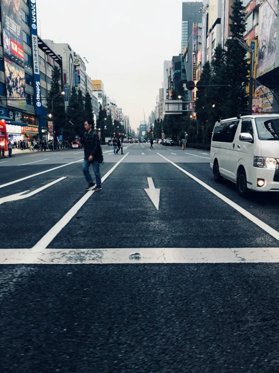 there is a white van stopped in the middle of the street