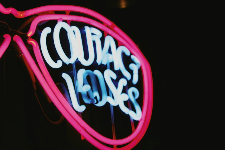 a neon sign that says co's loss on it