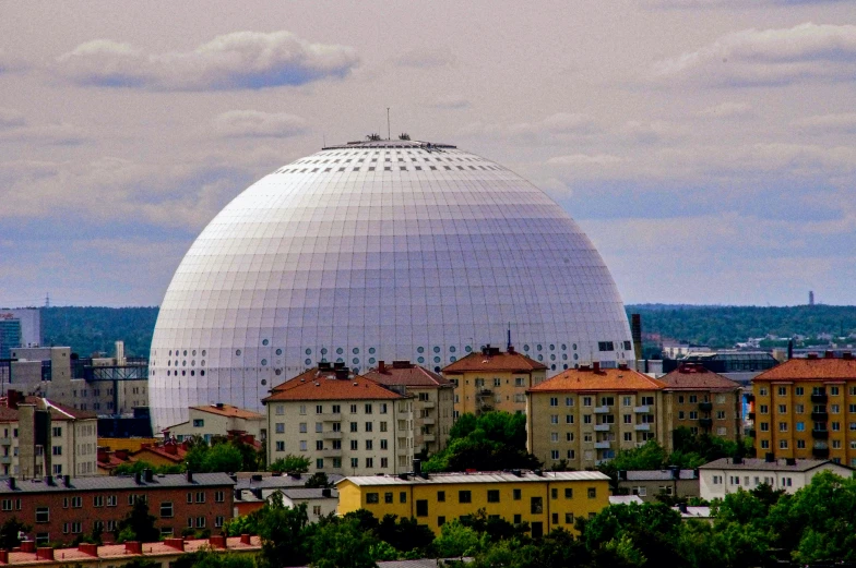 there is a large round structure that sits on top of a hill