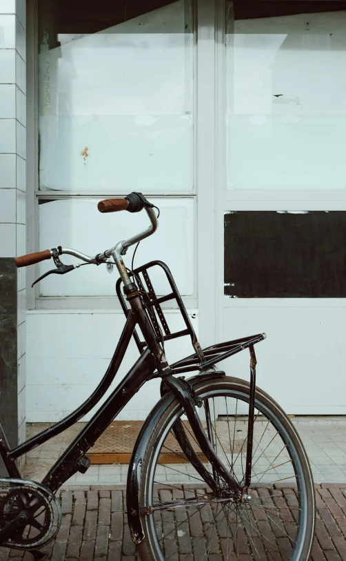 a black bike parked in front of a white door