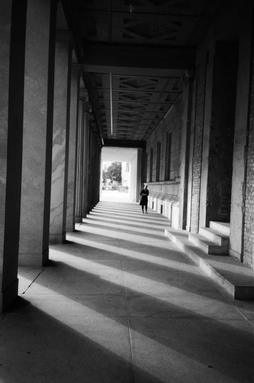 a person is walking down an empty corridor