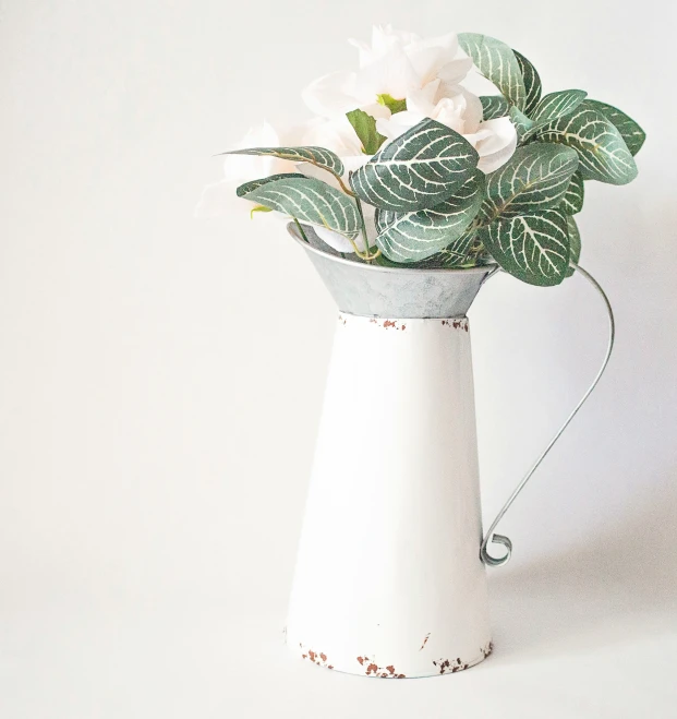 a ceramic vase has white flowers on it
