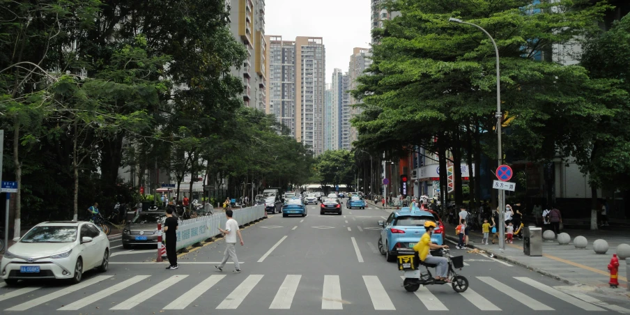 a man rides a skateboard across a busy street