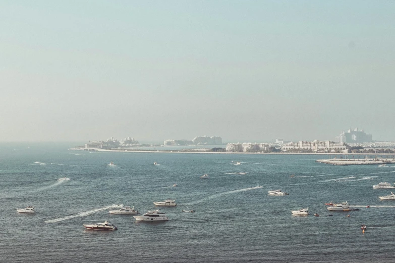 boats are out on the open water near a city