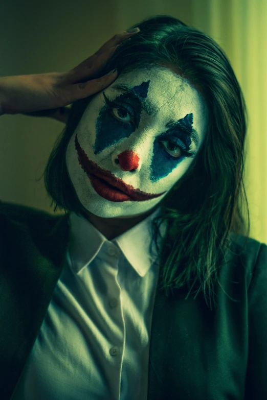 a person with makeup on wearing a clown make - up