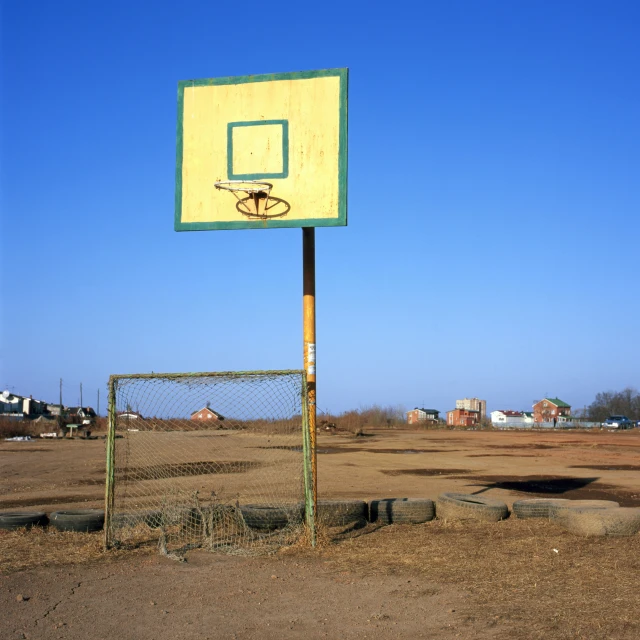 there is a basketball hoop on the side of a metal fence