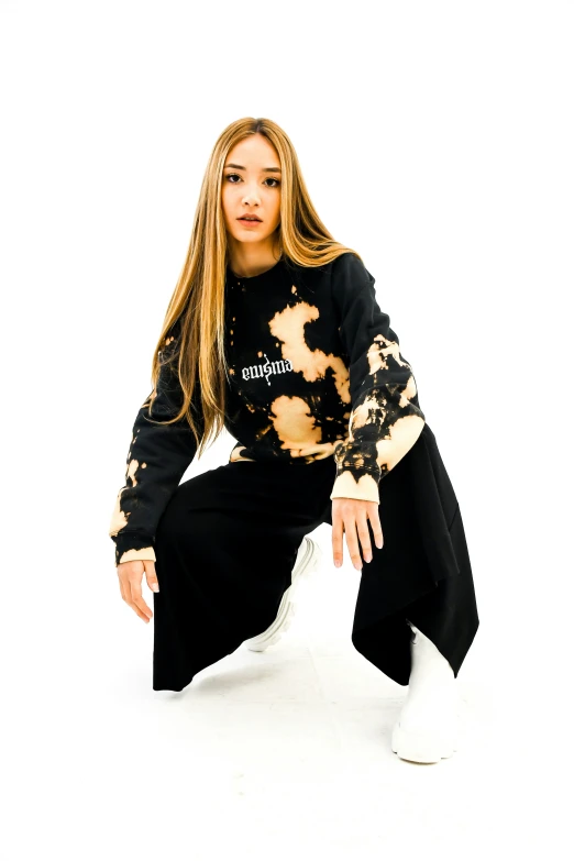 a young woman sitting on top of a white surface