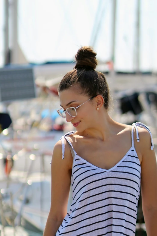 woman with a messy ponytail wearing a striped shirt