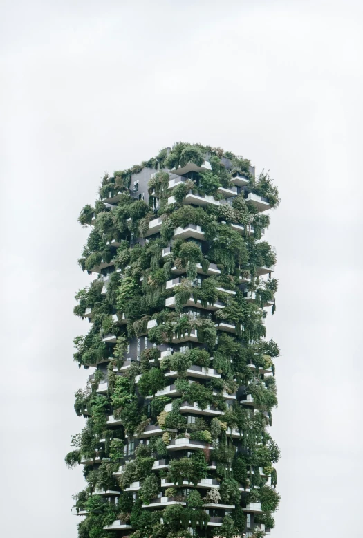 a tall tower building covered in plant life