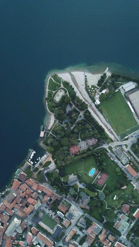 an aerial view of a small city and lake