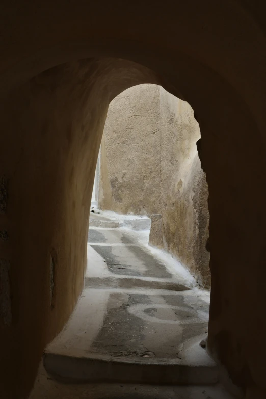 a narrow, stone passage that is between two buildings