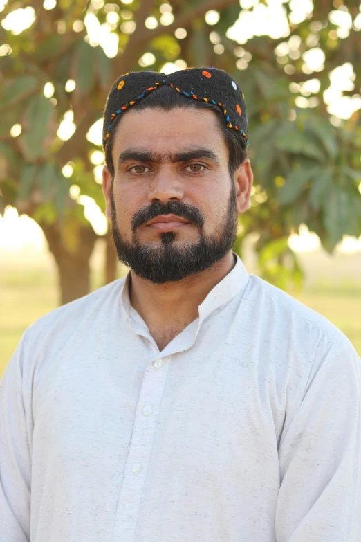 a man is standing outside in a white shirt