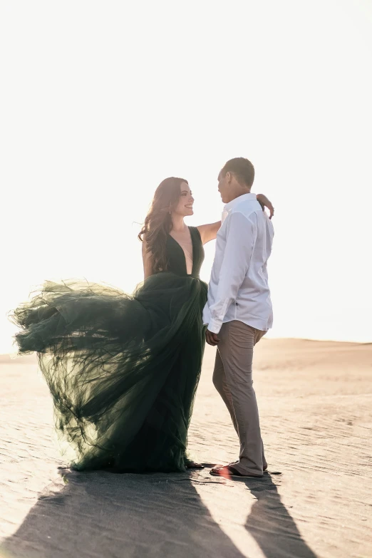 a couple posing for a picture with a desert background