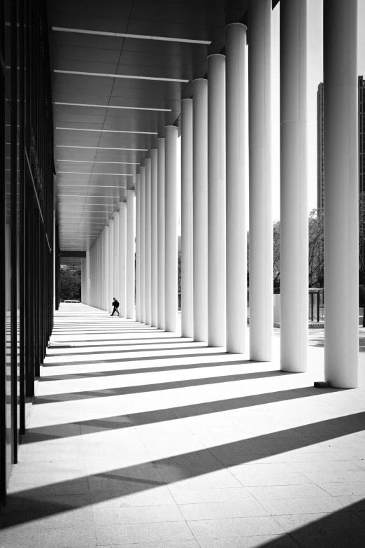 a long corridor with columns and lines on the side