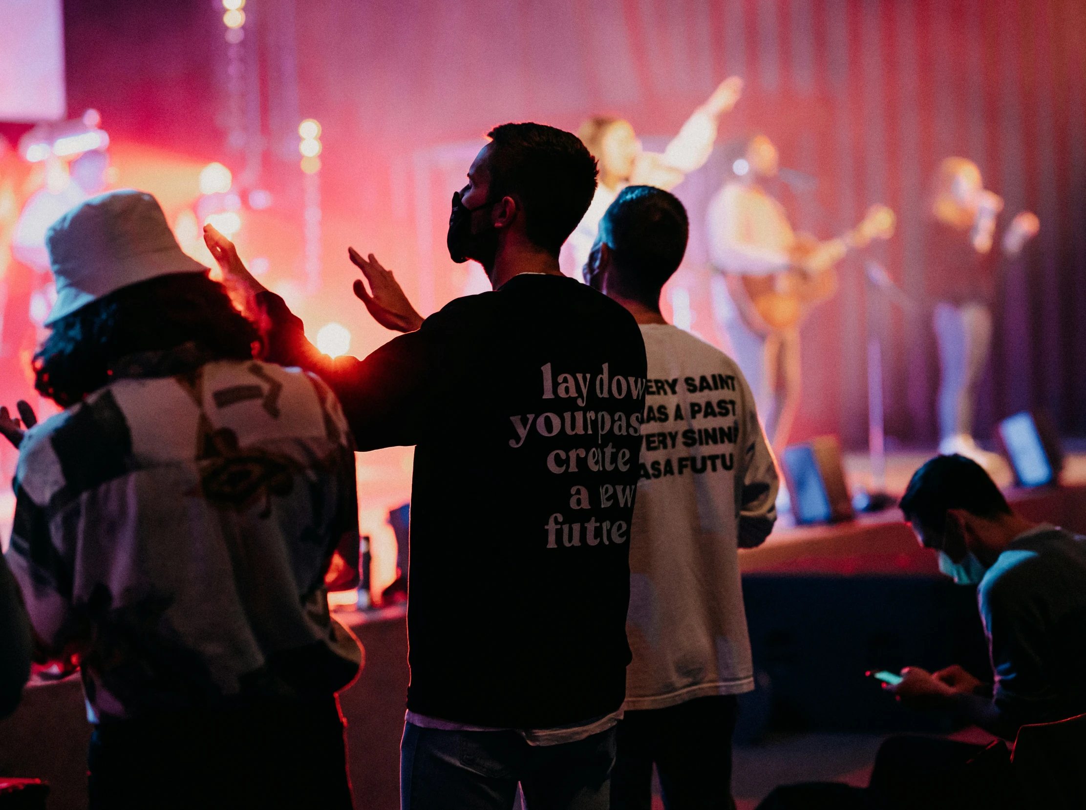 some people standing near a band on stage