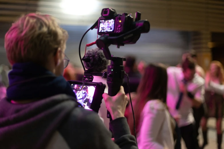 a person that is filming another person in the mirror