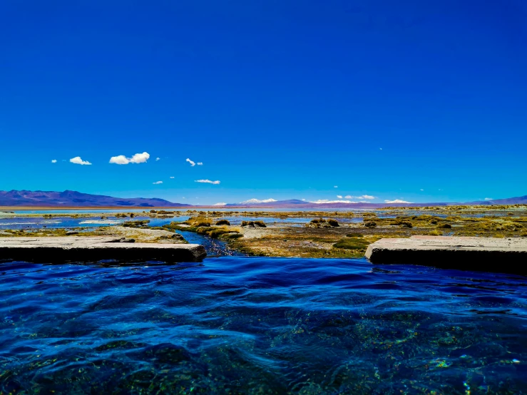 a view of water with mountains in the background