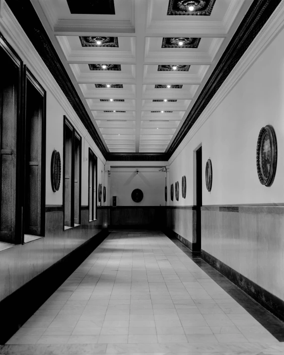 an image of a long hallway that is black and white