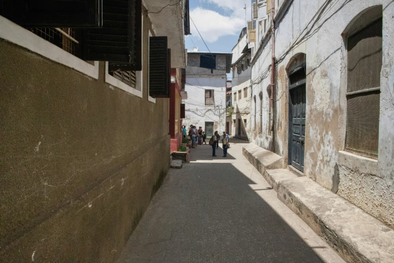 street scene with people walking and several buildings