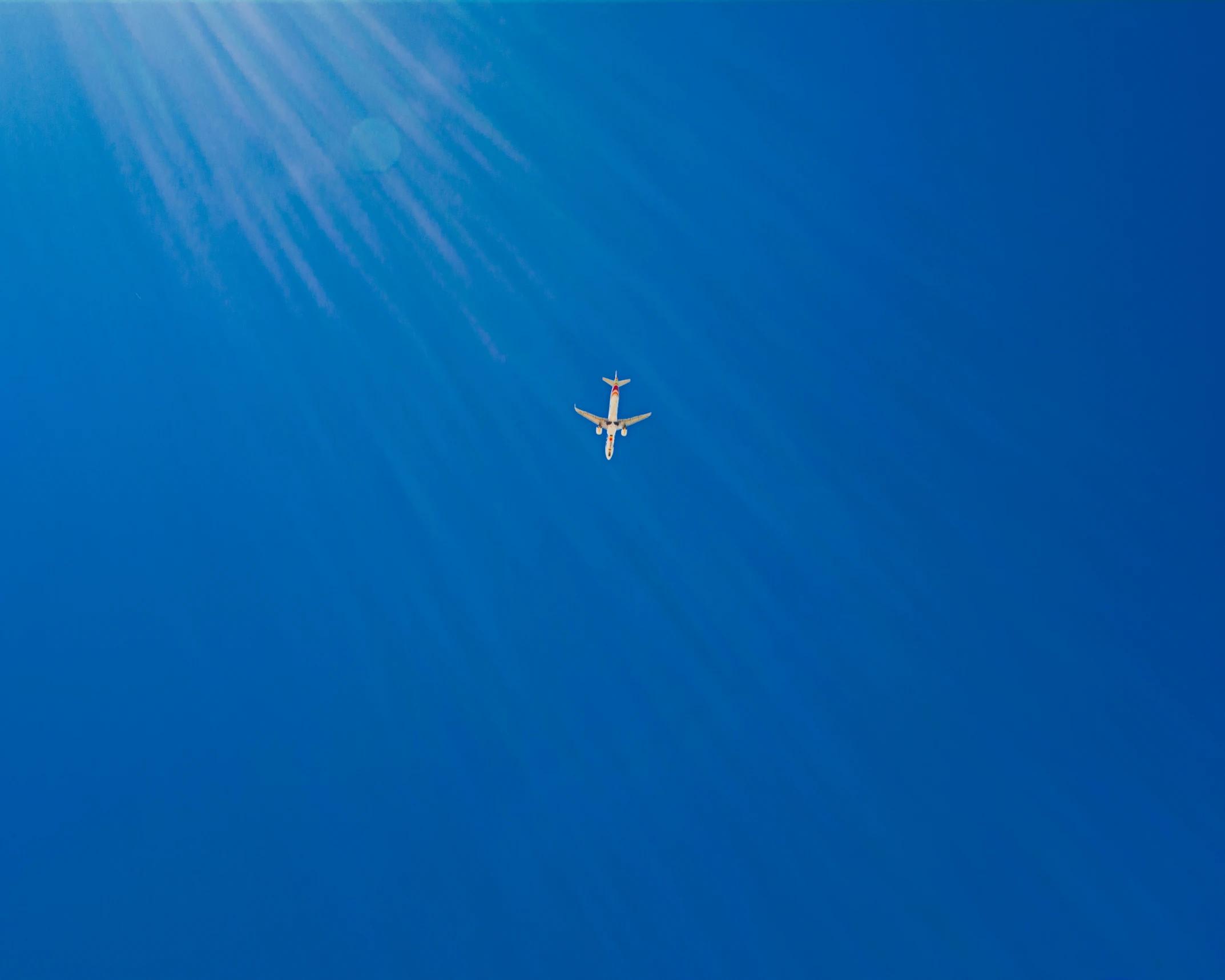 a plane flying through a bright blue sky