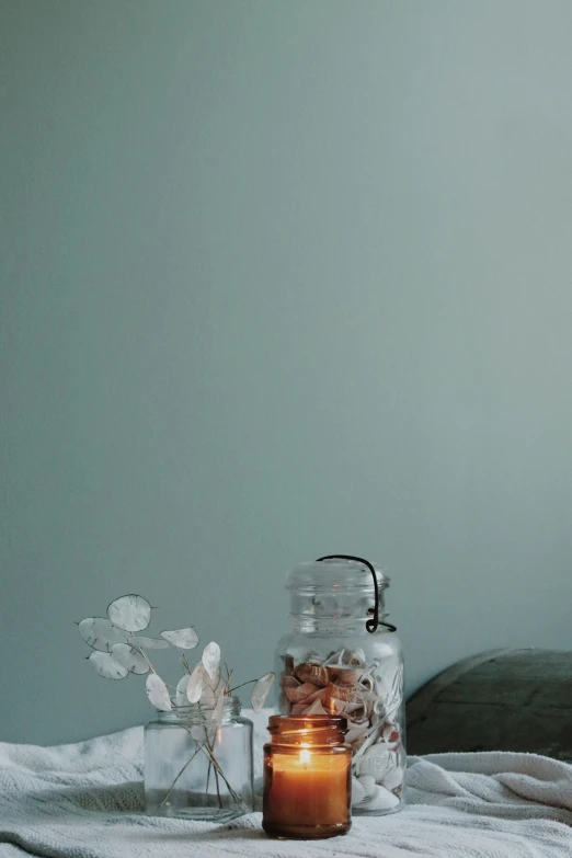 an assortment of jars with flowers next to them
