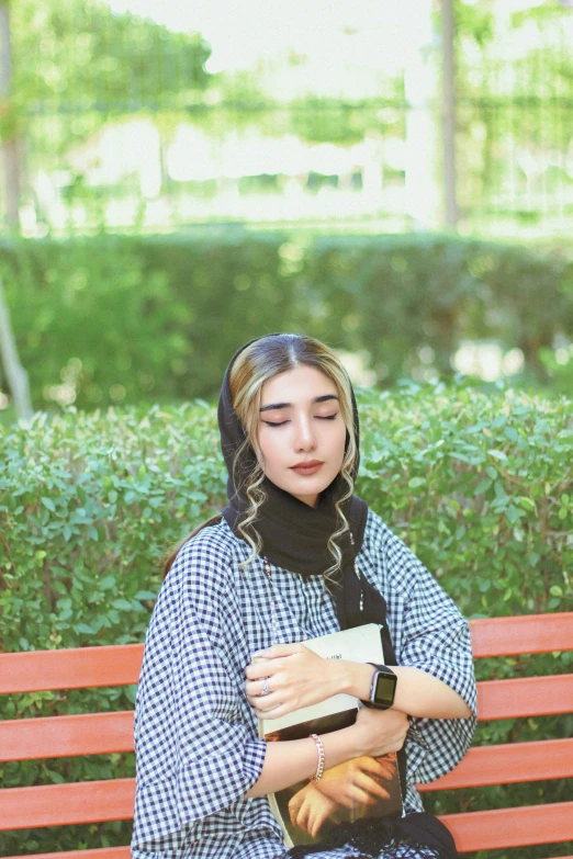 a woman sitting on a bench with her eyes closed