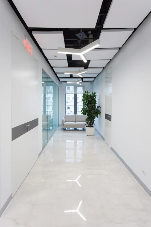 a long open, modern looking hallway that is white and grey