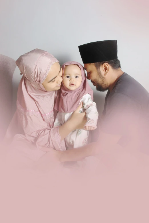 a man kisses a baby and is holding it