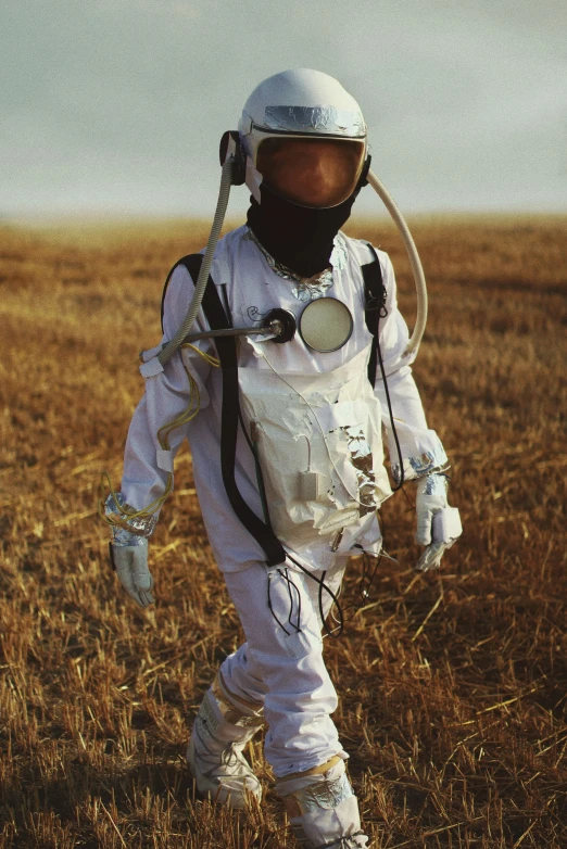 an astronaut walking through the field in a space suit