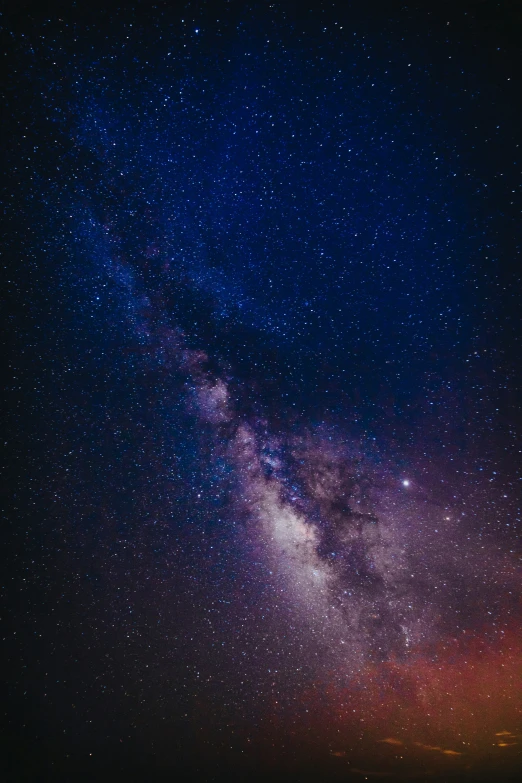 the night sky with bright stars and clouds