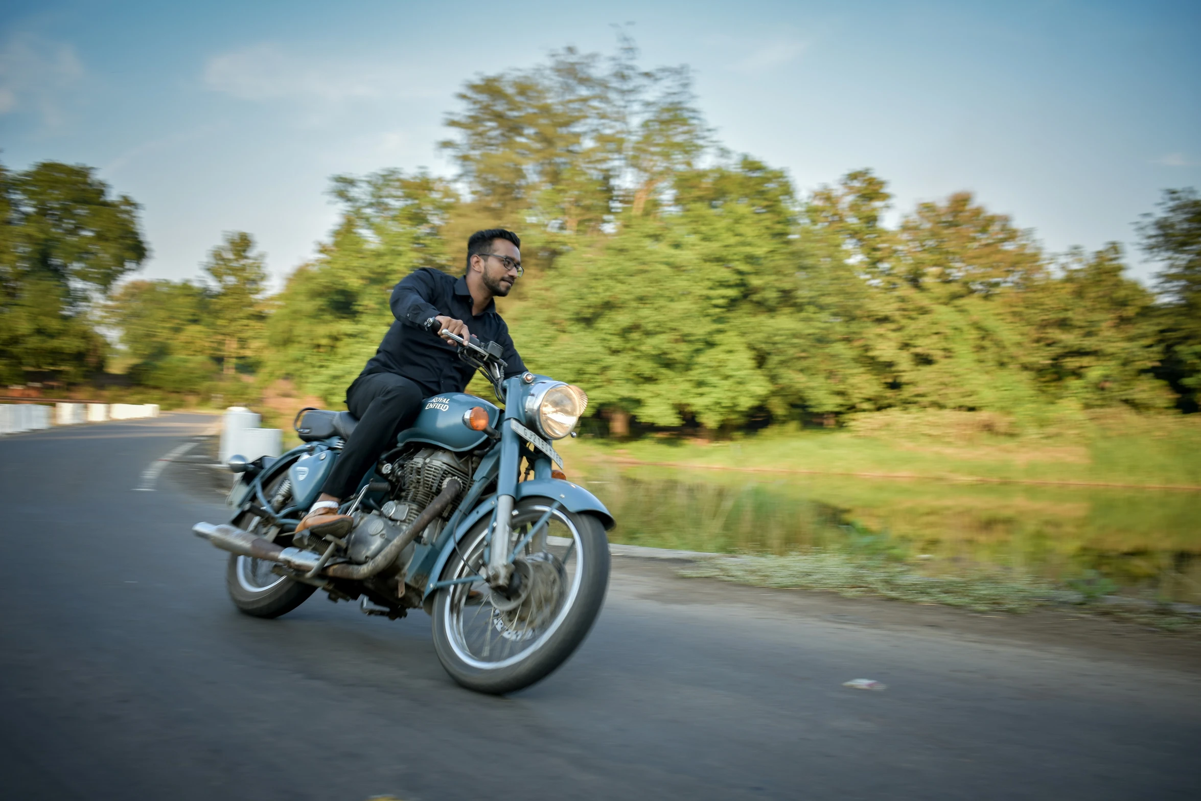 a man is riding a motorcycle down a road